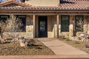 View of exterior entry with covered porch