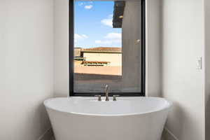 Bathroom featuring a tub to relax in