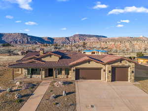 View of front facade with a garage and a mountain view