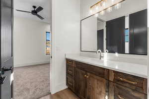 Bathroom featuring hardwood / wood-style floors, vanity, and ceiling fan