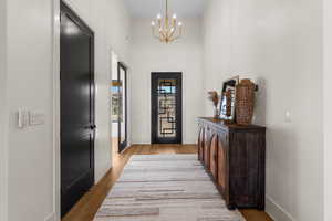 Interior space with light hardwood / wood-style floors and a chandelier