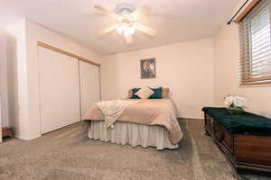 The primary Bedroom features a ceiling fan, carpet, two closets, and access to the bathroom