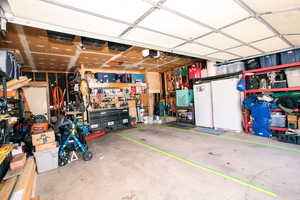 Garage with a garage door opener and a workshop area