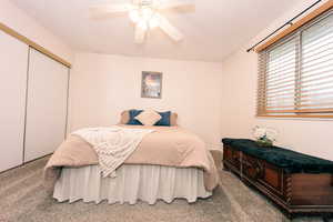 The primary Bedroom features a ceiling fan, carpet, two closets, and access to the bathroom