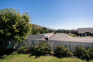 Backyard view featuring a mountain view and church parking lot.