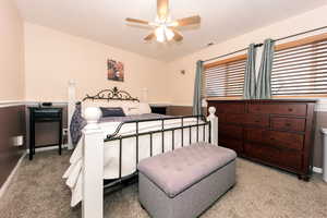 Carpeted bedroom with ceiling fan