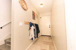 Entryway with light tile patterned floors