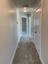 Hallway featuring carpet floors