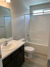 Full bathroom featuring  shower combination, toilet, and vanity