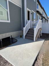 Property rear entrance with a patio and fence