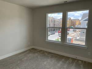 Bedroom 2 featuring plenty of natural light and carpet flooring