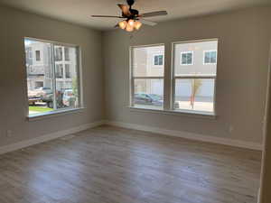 Unfurnished room with ceiling fan and light hardwood / wood-style flooring