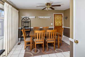 Dining area featuring light tile patterned floors and ceiling fan