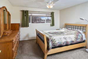 Bedroom featuring dark carpet and ceiling fan