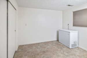 Washroom with a textured ceiling