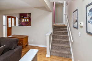 Staircase featuring hardwood / wood-style floors