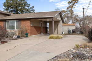 View of property exterior with a carport