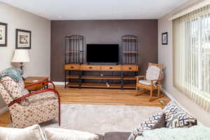 Living room with wood-type flooring