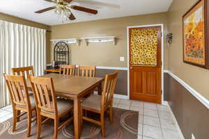 Dining space featuring light tile patterned flooring and ceiling fan