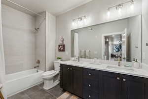 Full bathroom with vanity, shower / bath combination with curtain, and toilet