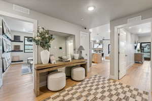 Home office with a wealth of natural light and light hardwood / wood-style floors