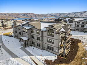 Snowy aerial view featuring a mountain view