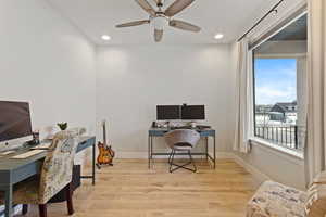 Office area featuring light hardwood / wood-style flooring and ceiling fan