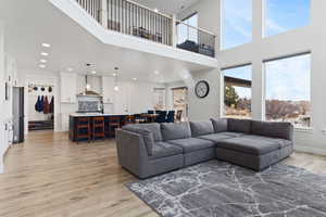 Living room featuring sink and light hardwood / wood-style flooring