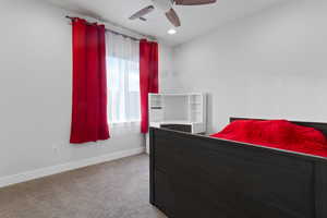 Carpeted bedroom with ceiling fan