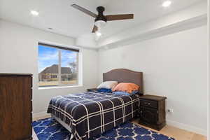 Bedroom featuring ceiling fan and wood-type flooring