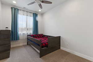 Bedroom with light colored carpet and ceiling fan