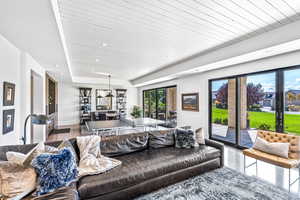 Living room featuring wooden ceiling and a raised ceiling