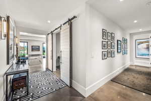 Corridor with a barn door and concrete flooring