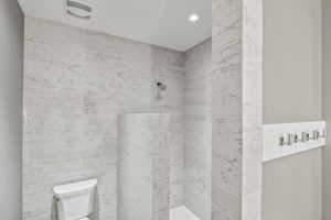 Bathroom with tiled shower and toilet