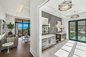 Bathroom featuring tile walls, vanity, and french doors