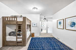 Carpeted bedroom with wood walls