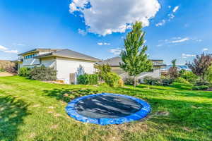 View of yard featuring a trampoline