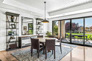 Dining area with wood ceiling and a raised ceiling