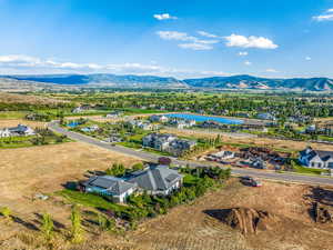 Birds eye view of property featuring a water and mountain view