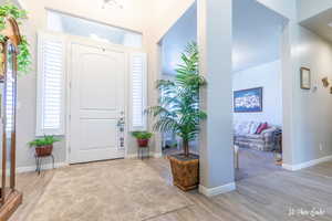 Entrance foyer with light hardwood / wood-style flooring