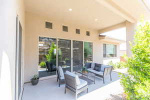 View of patio with an outdoor hangout area