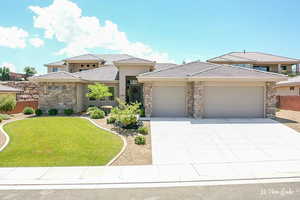 Prairie-style home featuring a garage and a front yard