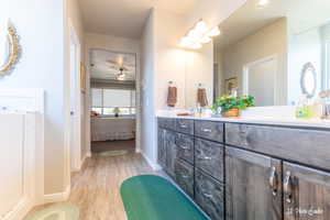 Bathroom with ceiling fan, wood-type flooring, and vanity