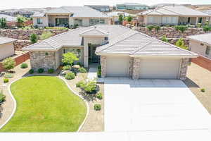 View of front facade with a garage and a front lawn