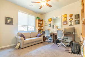 Carpeted office with ceiling fan