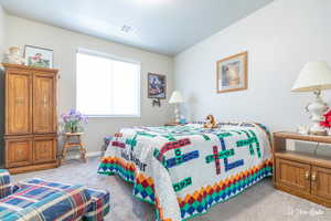 Bedroom featuring light colored carpet