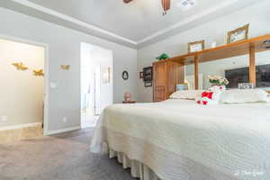 Carpeted bedroom with ceiling fan