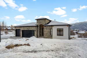 View of front of house featuring a mountain view and garage