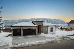 View of front of property with a mountain view and a garage