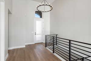 Foyer entrance with a towering ceiling, hardwood / wood-style floors